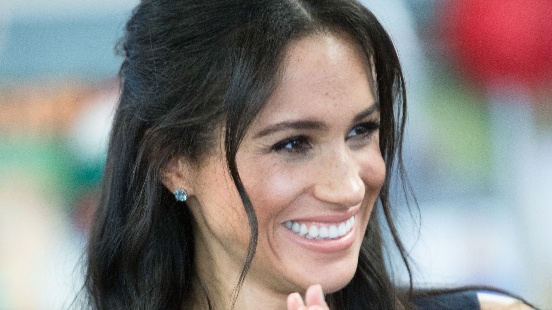 Meghan, Duchess of Sussex smiling with hands up held together