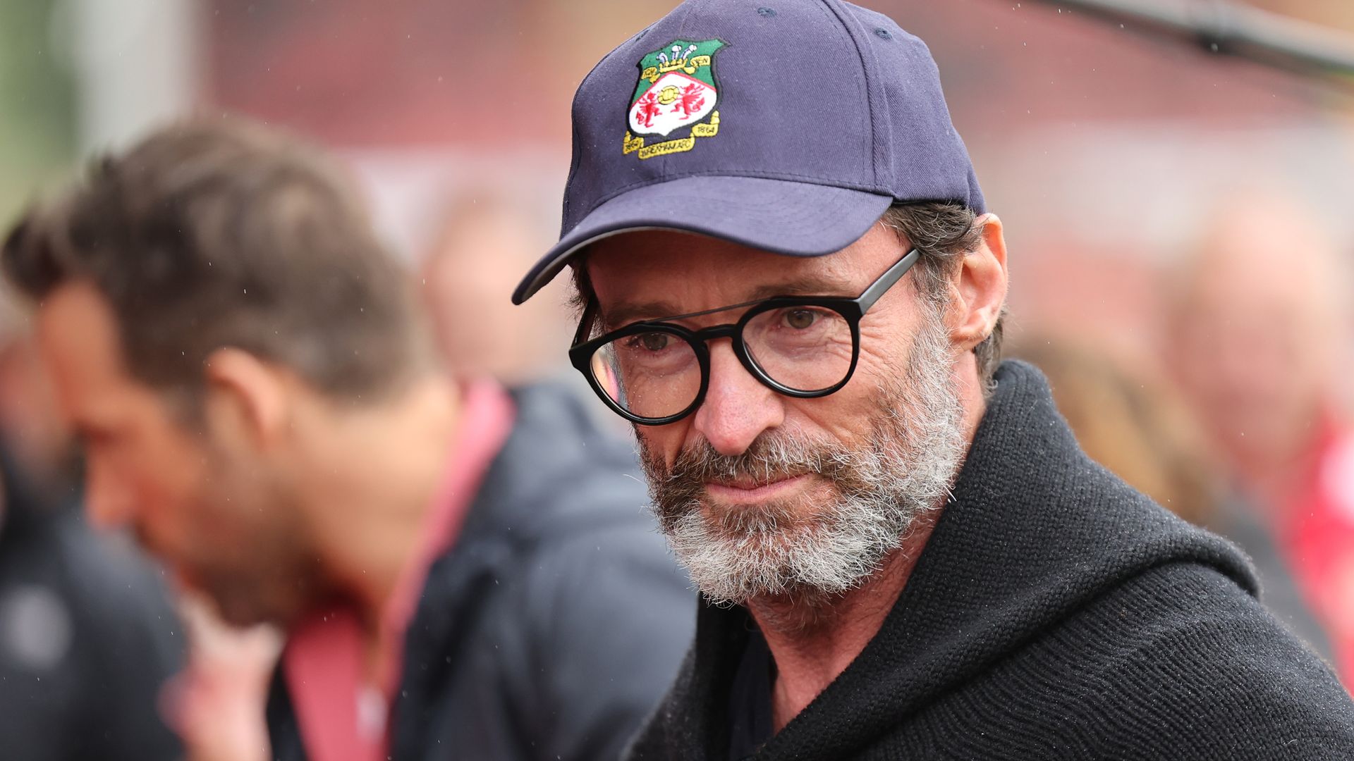 Hugh Jackman in a cap looking serious