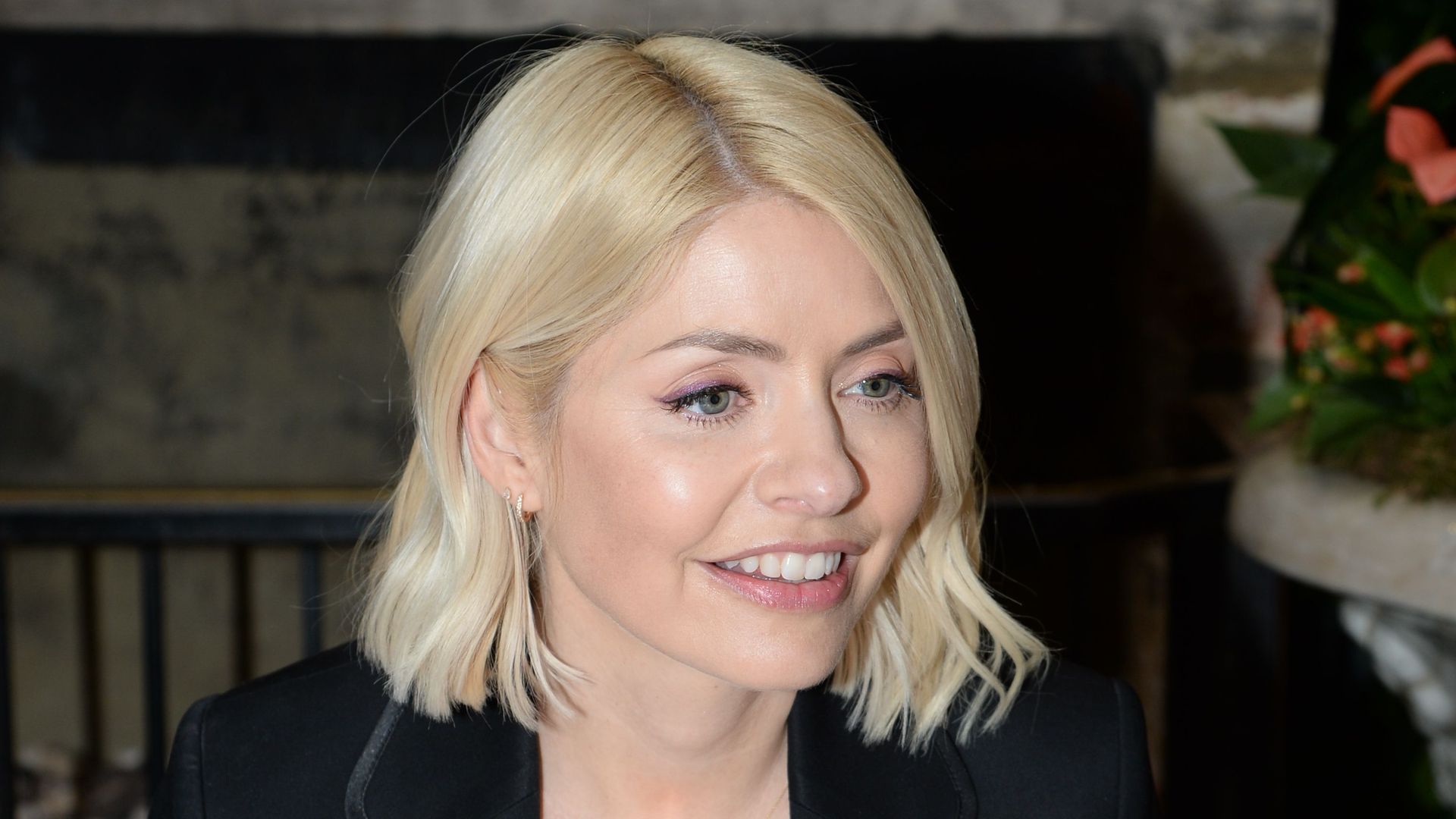 Holly Willoughby smiling in a black blazer