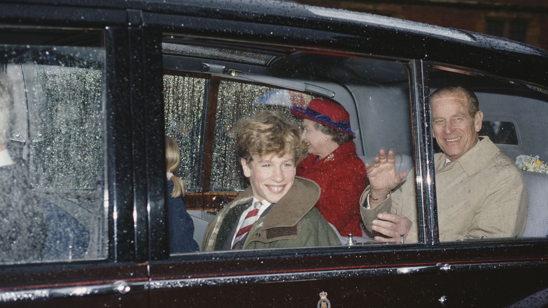 Peter Phillips smiling with Queen and Prince Philip in 1991