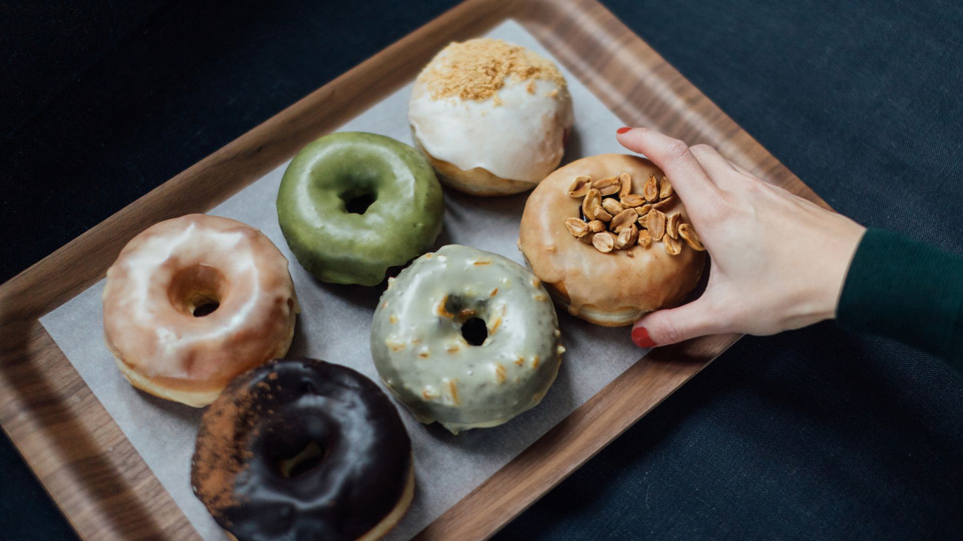 woman hand reaching for doughnut
