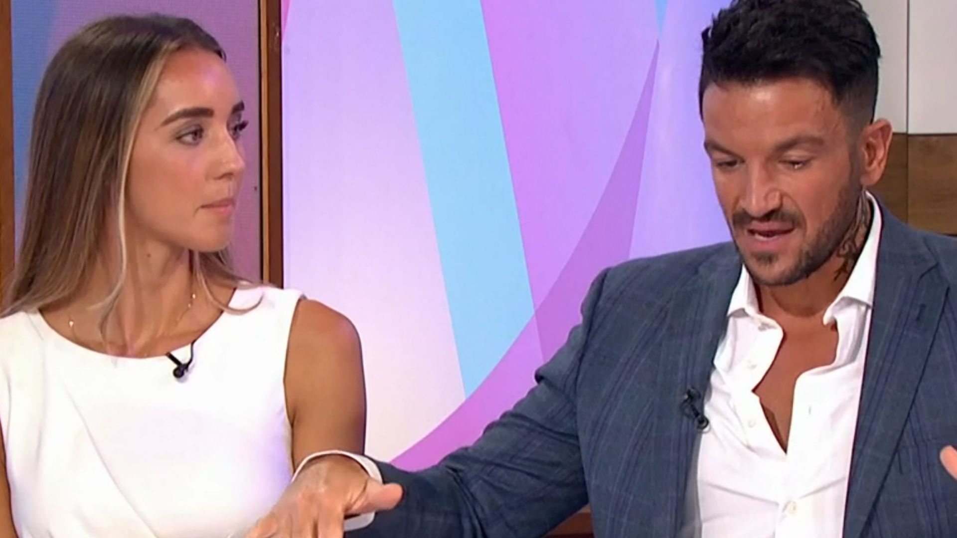 Peter Andre gesturing with his arms while Emily watches in a white dress on Loose Women