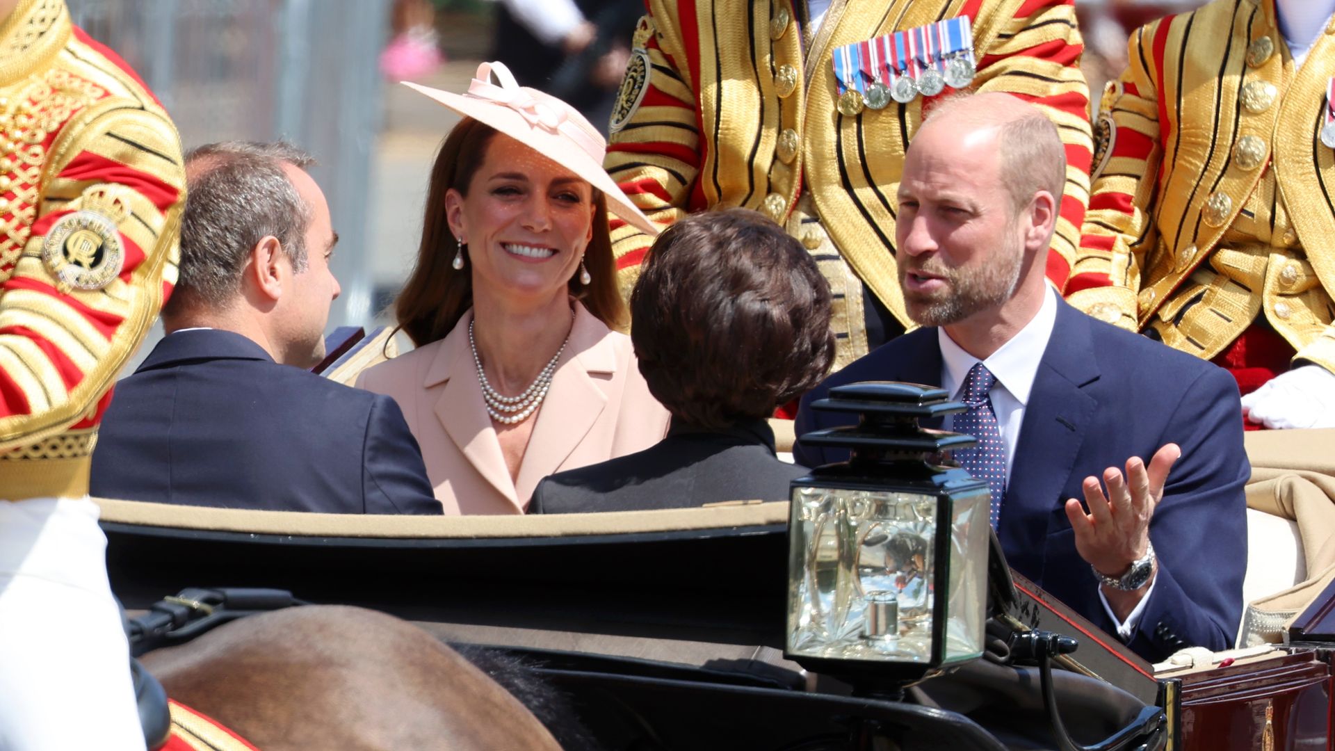 Princess Kate and Prince William riding alongside two French politicians