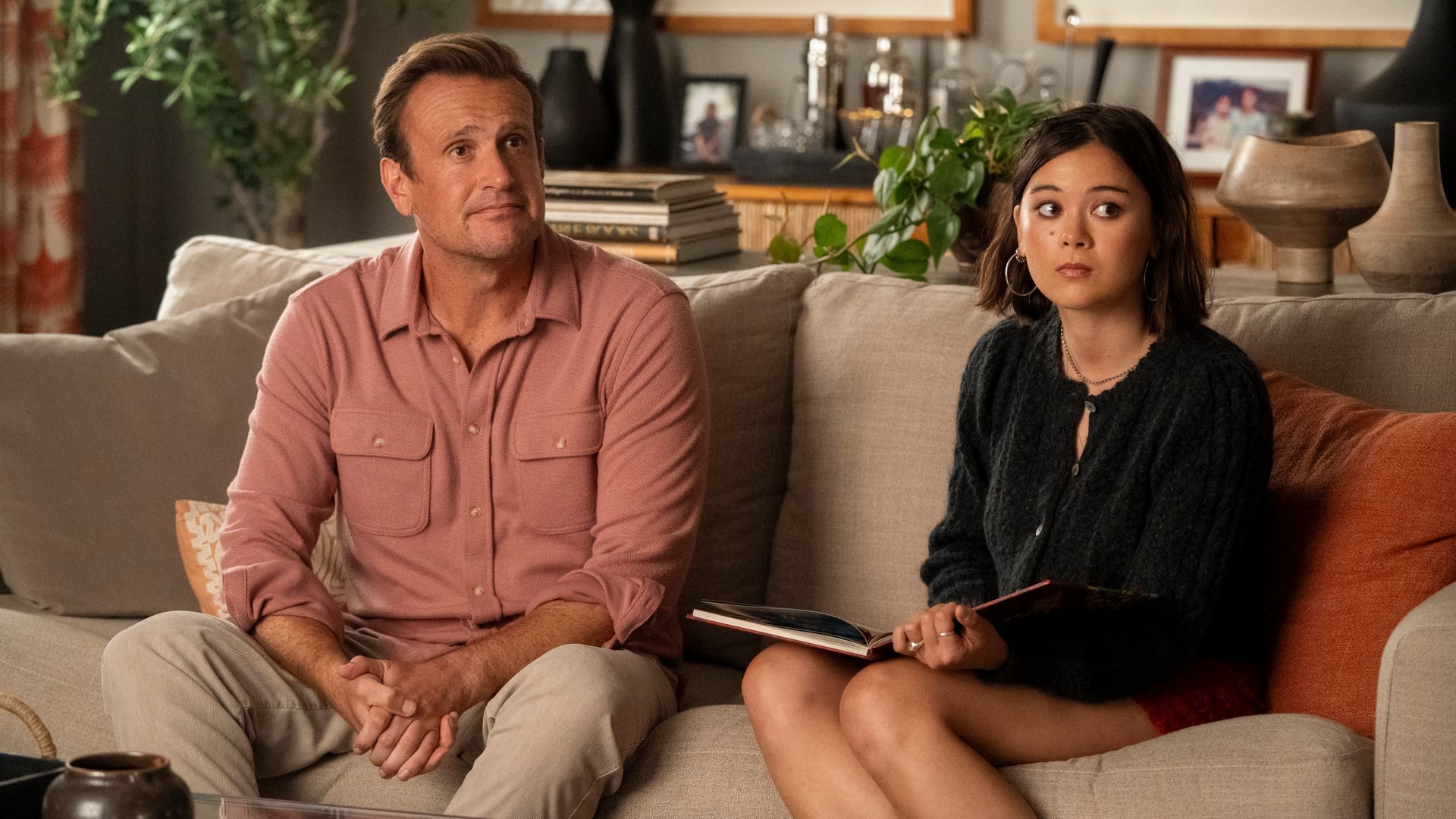 man and woman sitting on sofa