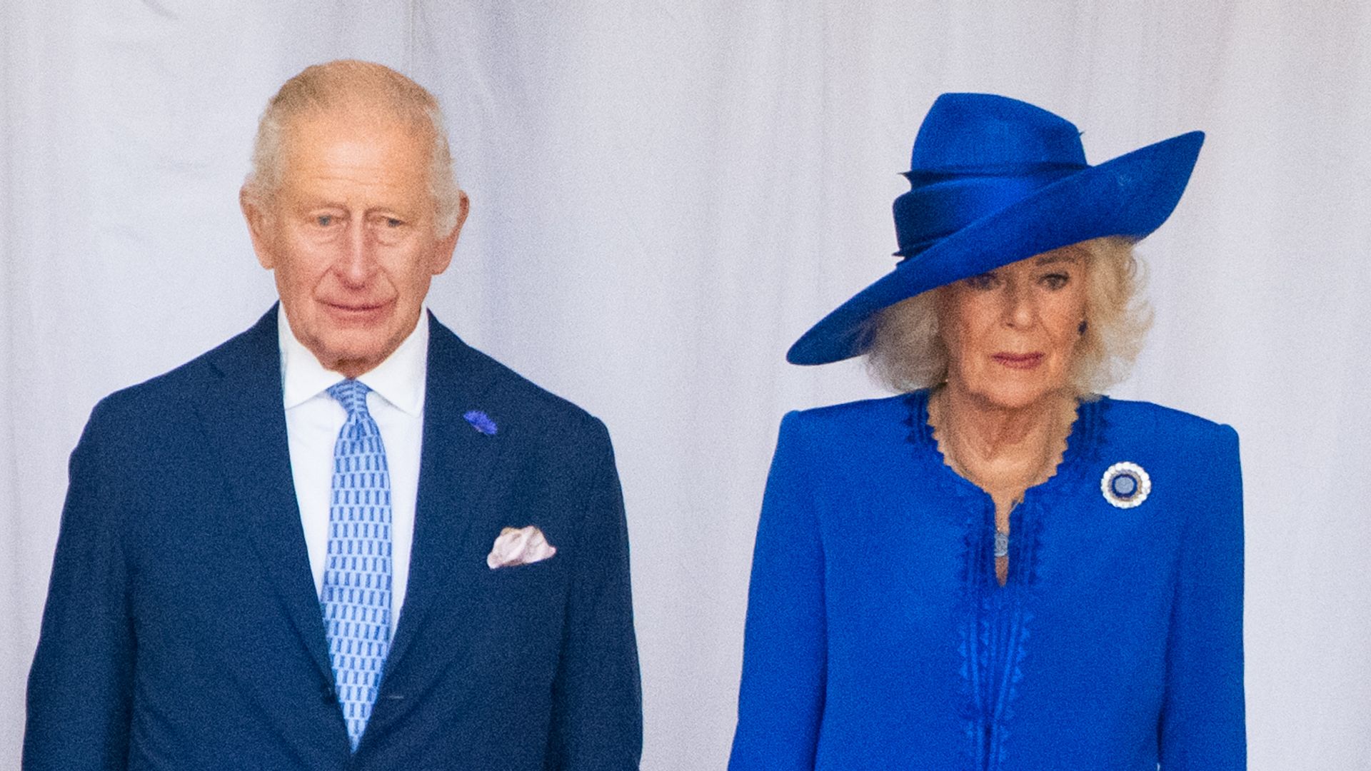 King Charles and Queen Camilla looking glum