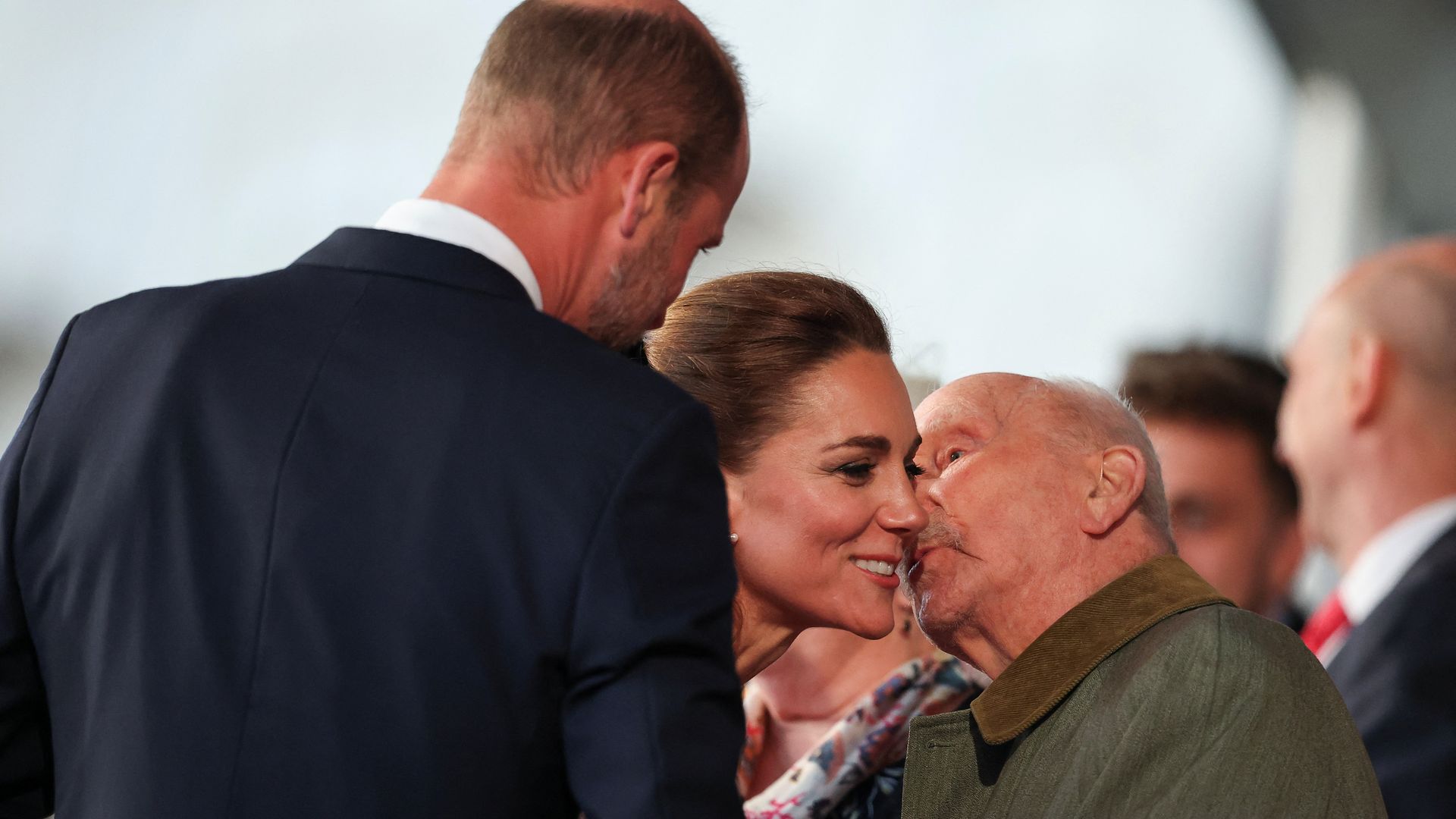 A veteran kissing Kate Middleton on the cheek