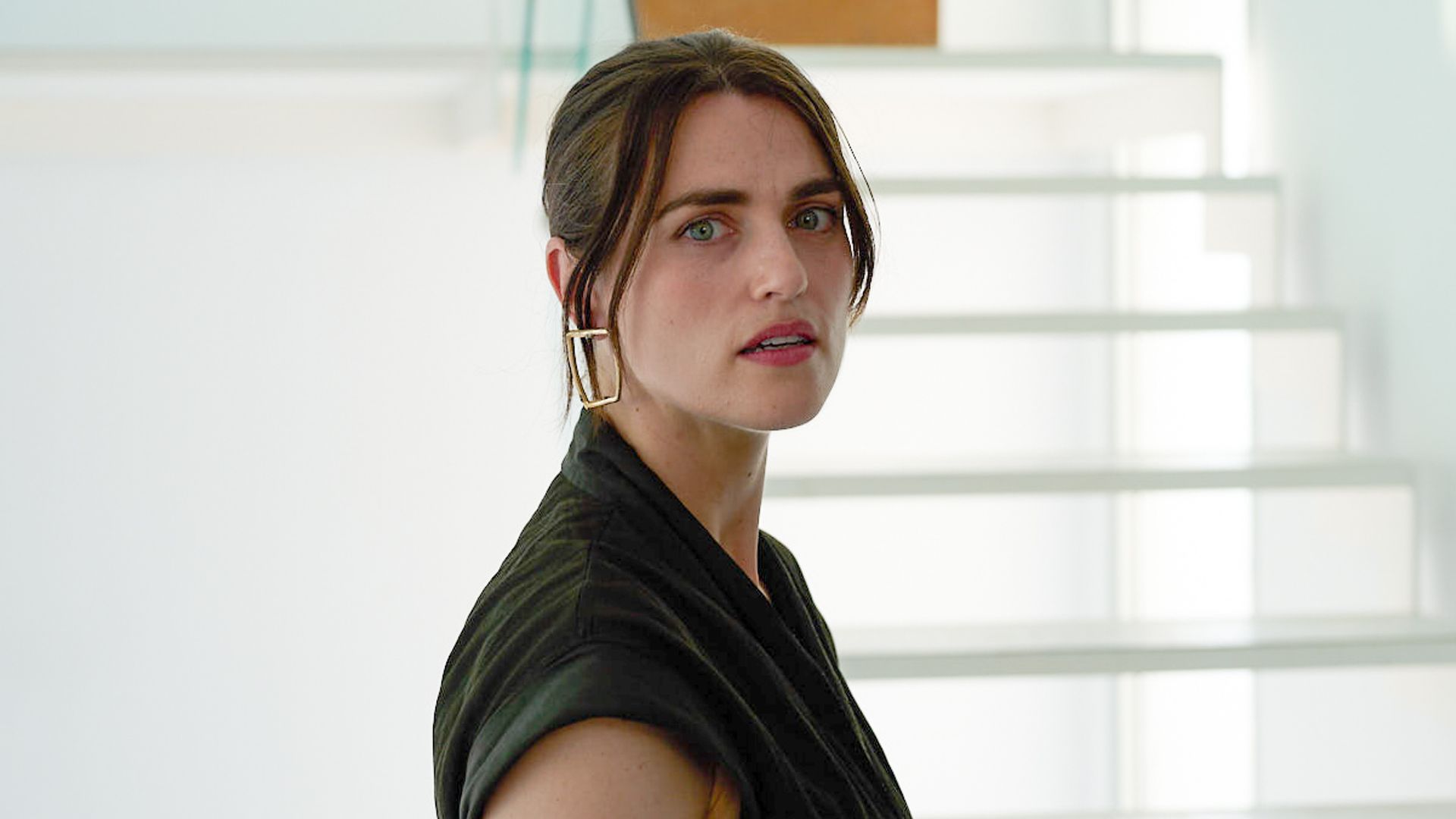 woman standing next to clear staircase