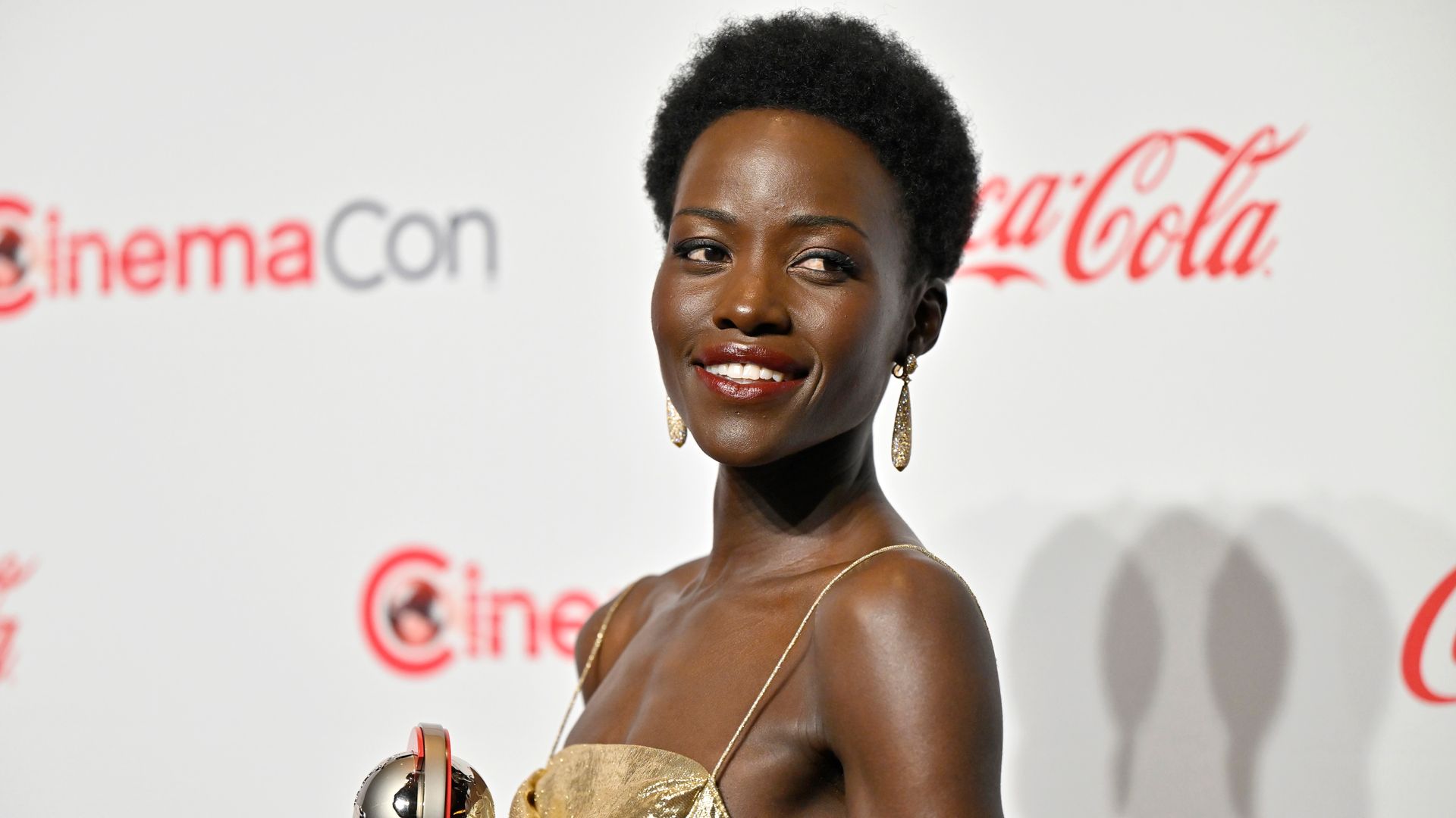 Lupita Nyong'o is a goddess in molten gold backless gown