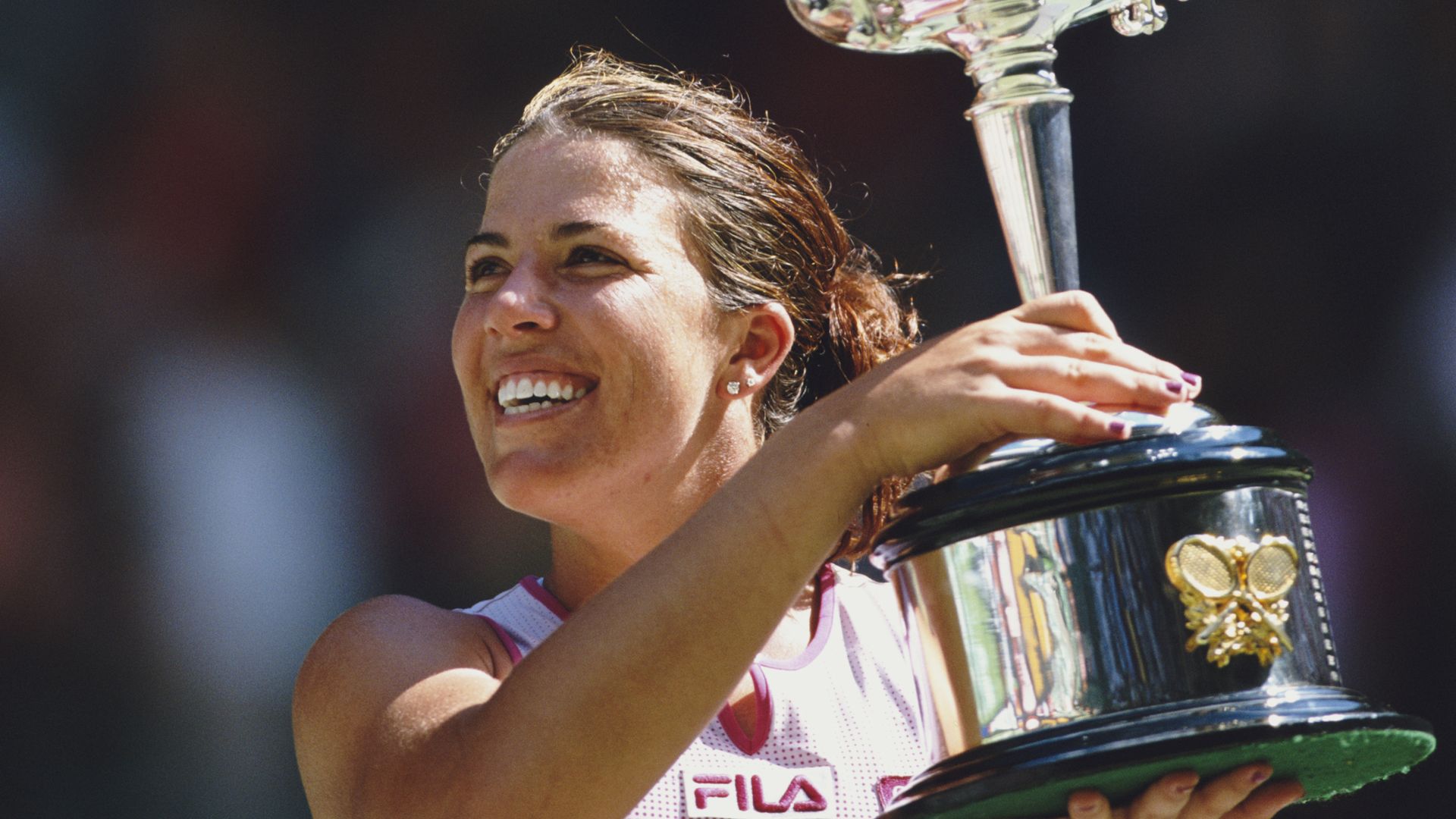 Jennifer Capriati of the United States lifts the trophy after winning the Women's Singles title against Martina Hingis at the Australian Open tennis tournament on 25 January 2002 at the National Tennis Centre at Melbourne Park, Melbourne, Australia