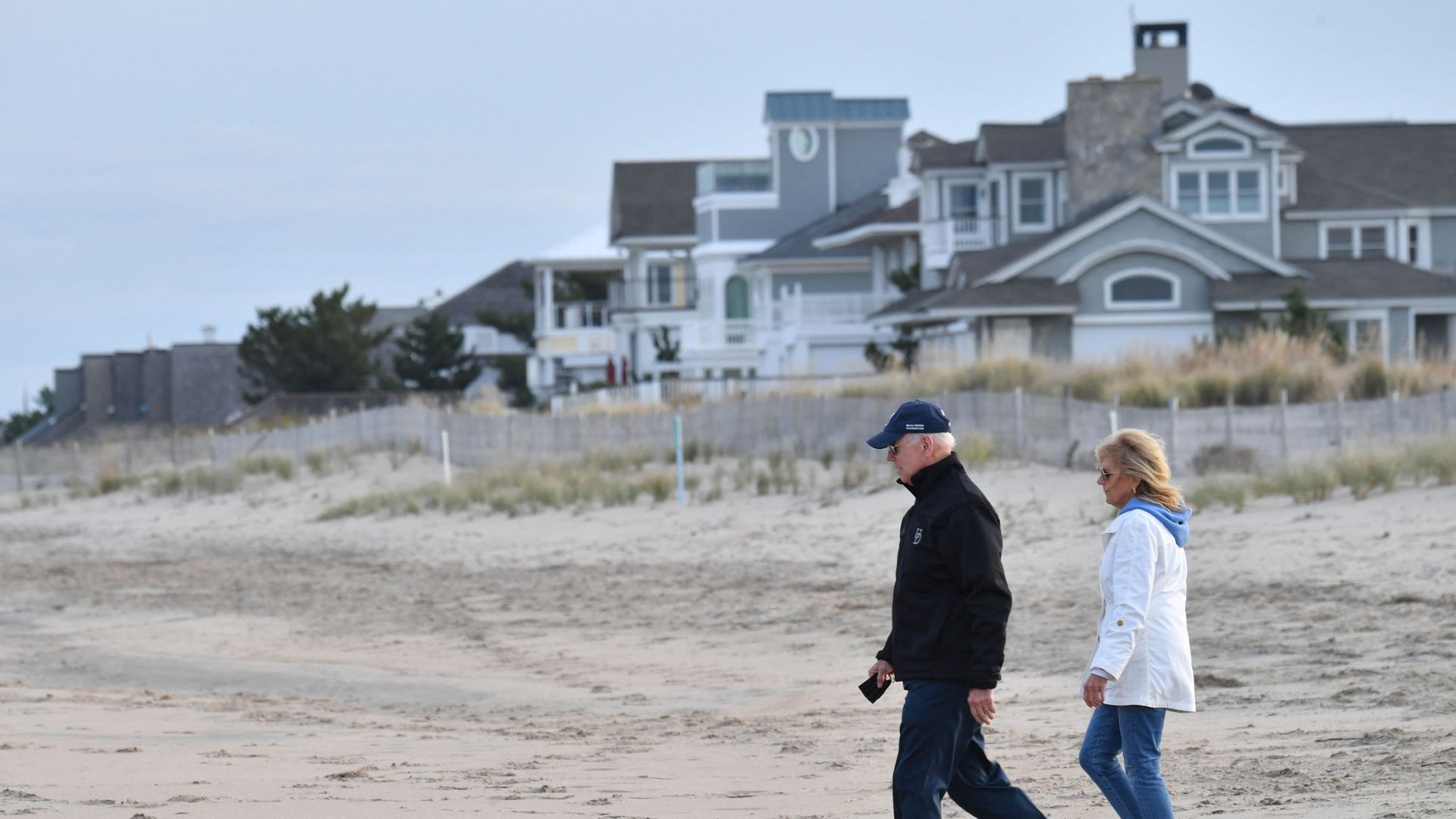 US President Joe Biden and First Lady Jill Biden walk on Rehoboth Beach, Delaware on November 7, 2021.