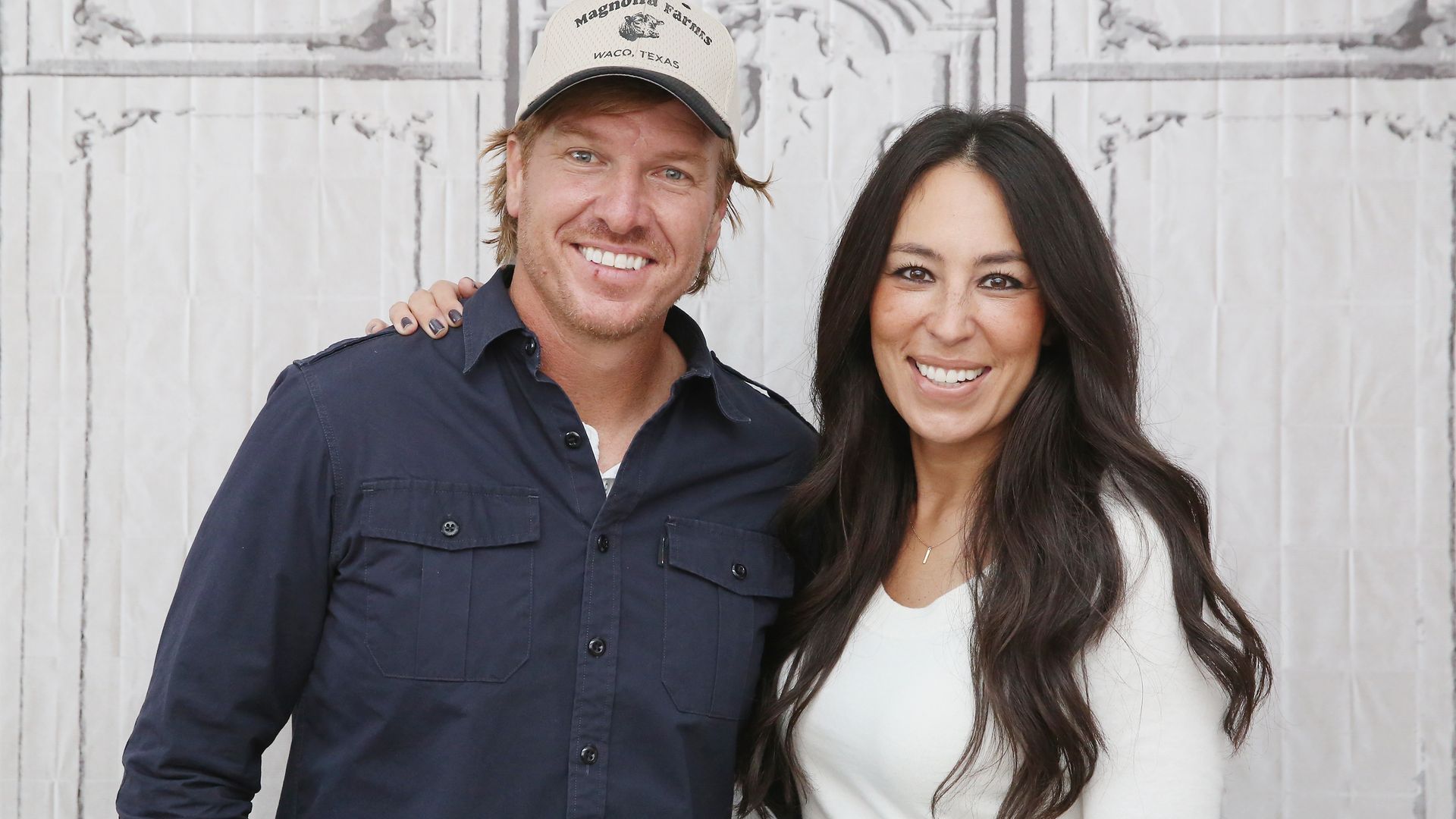 joanna gaines chip gaines smiling arms around each other
