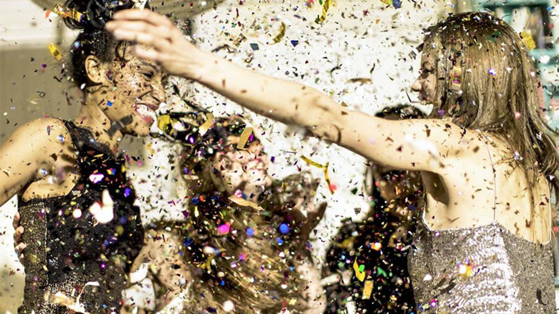 women throwing glitter party