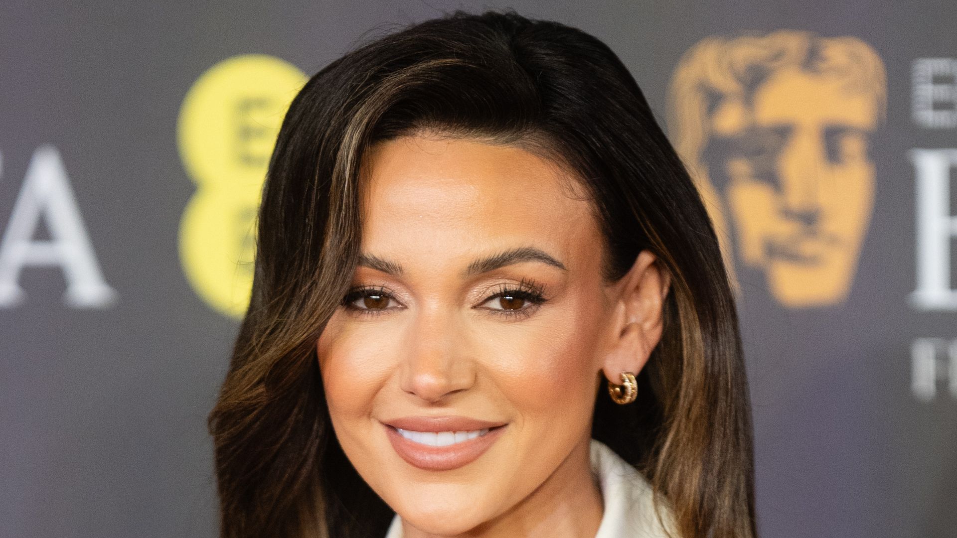 Michelle Keegan in a black dress with an oversized white collar