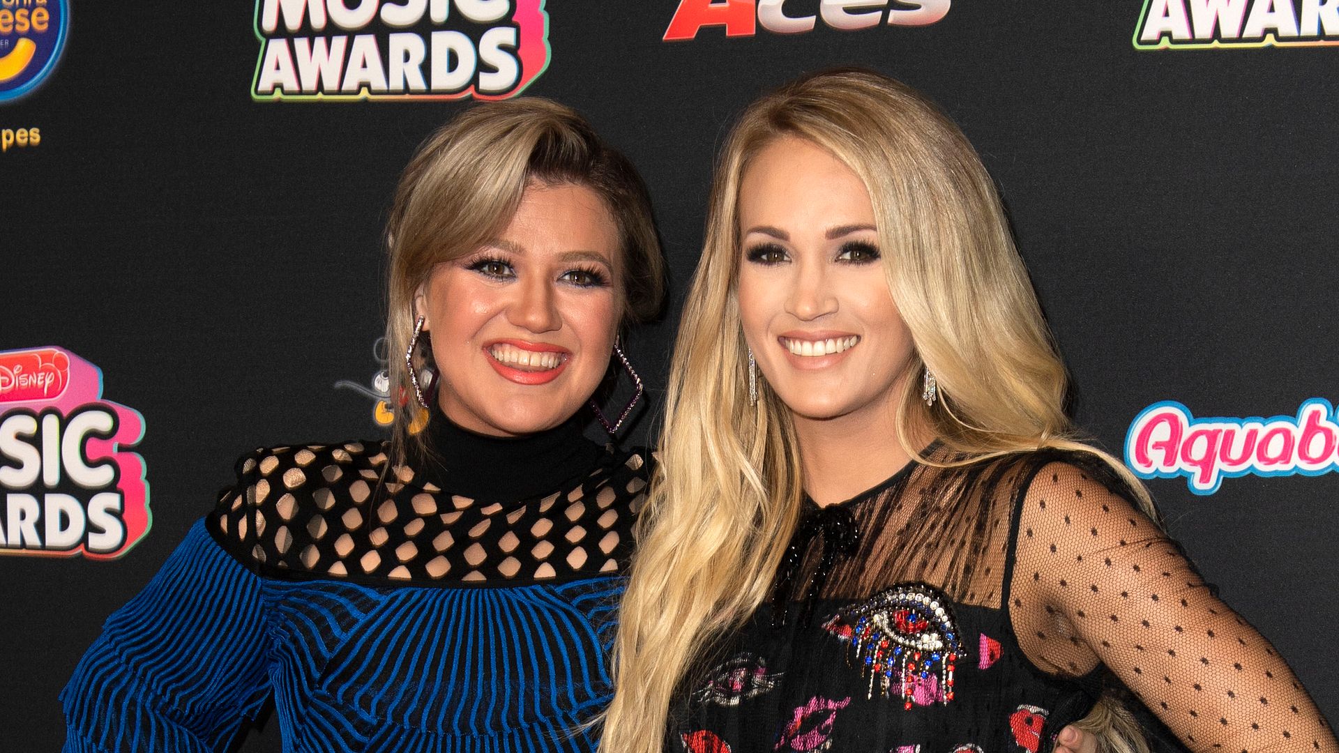 Kelly Clarkson and Carrie Underwood attend the 2018 Radio Disney Music Awards at Loews Hollywood Hotel on June 12, 2018 in Hollywood, California