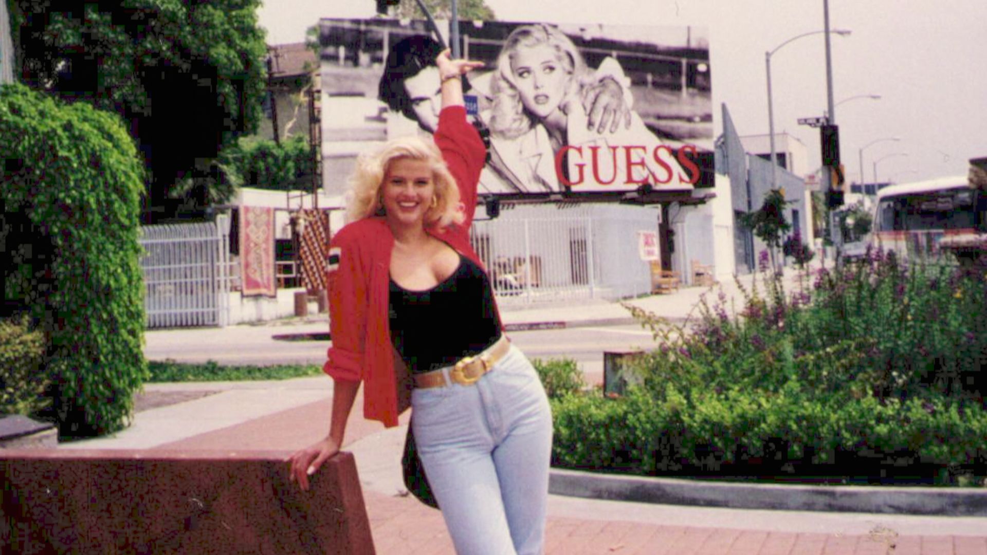 Anna Nicole Smith stands in front of billboard in Netflix documentary You Don't Know Me