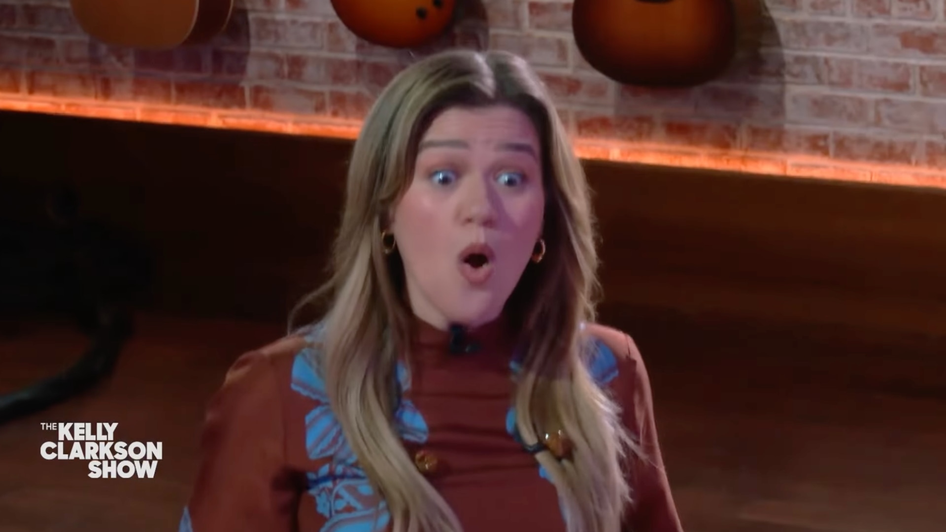 Still from Kelly Clarkson Show of her shocked at the arrival of Ben Affleck and Jon Bernthal with cakes and flowers for her 43rd birthday, April 24, 2025
