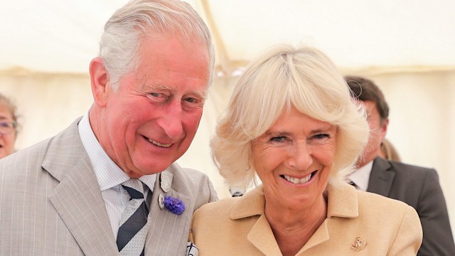 Charles puts his arm round Camilla as he sings happy birthday at the National Parks Big Picnic celebration