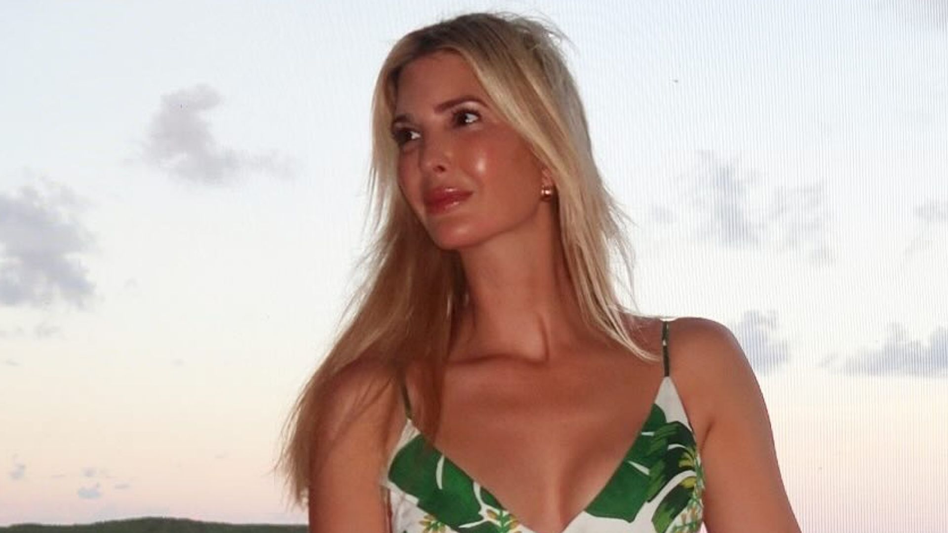 photo of ivanka trump in leaf print dress standing on a balcony 