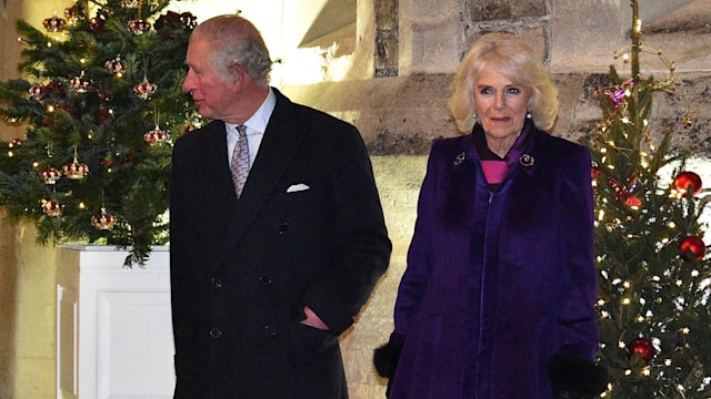 King Charles and Queen Camilla in front of Christmas trees