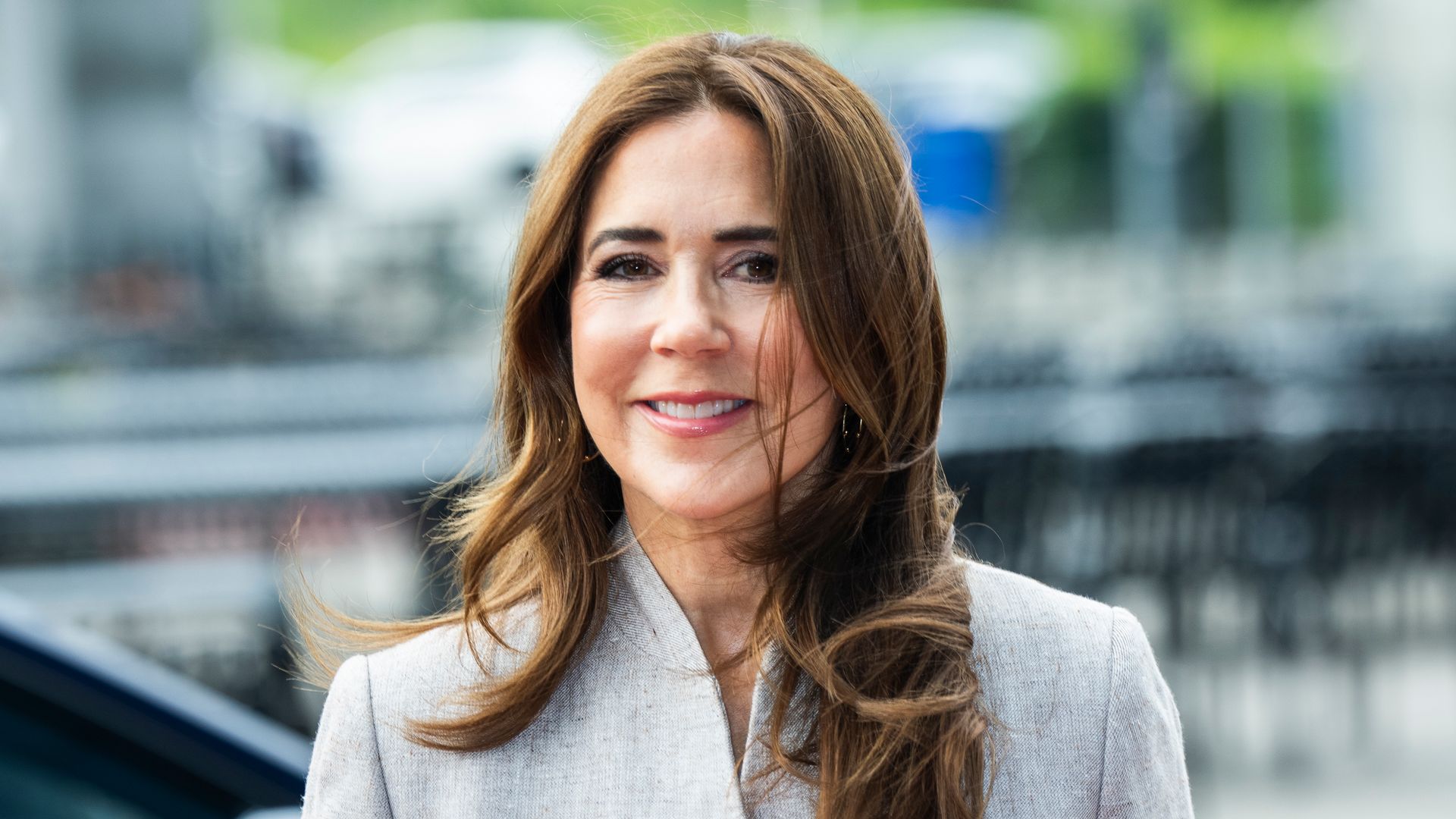  Queen Mary in grey suit with windswept hair