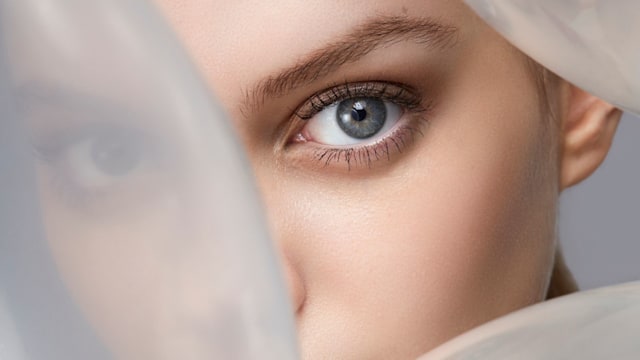 Woman peering from between balloons 