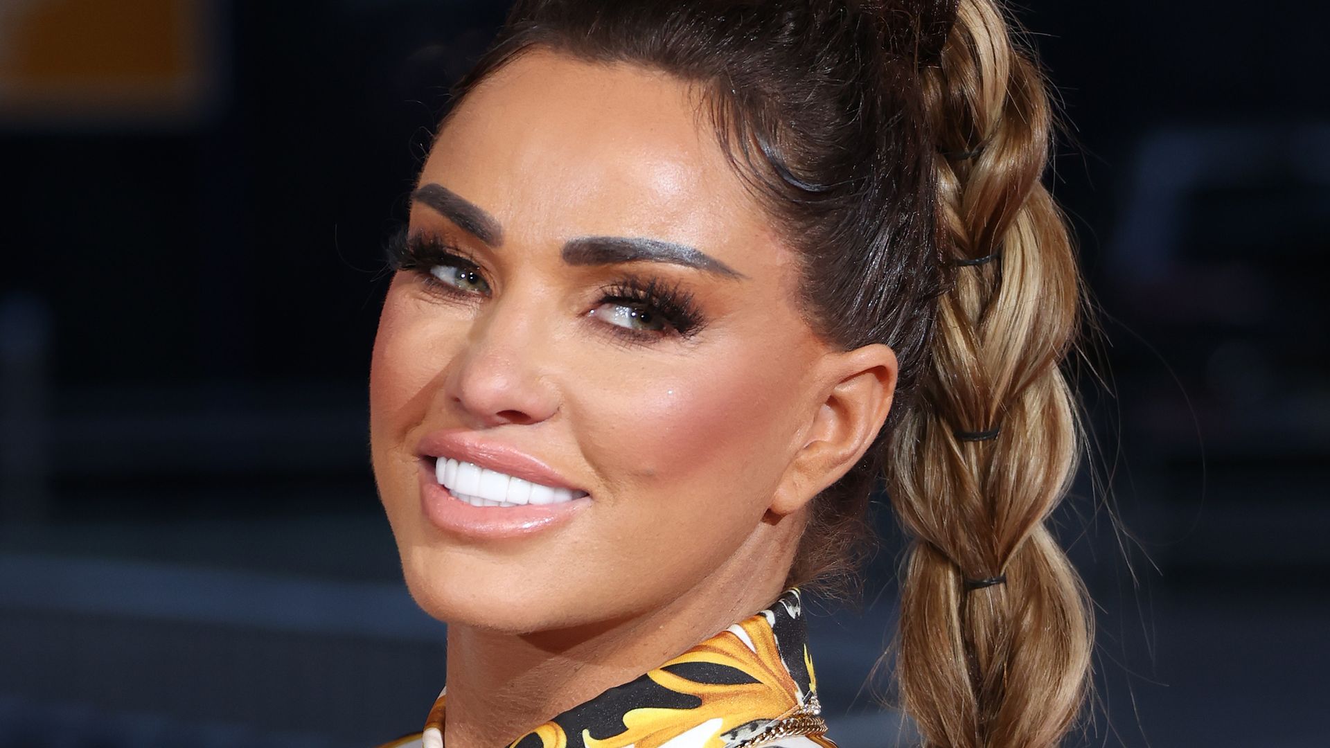 Katie Prices smiling for a photo at a red carpet event