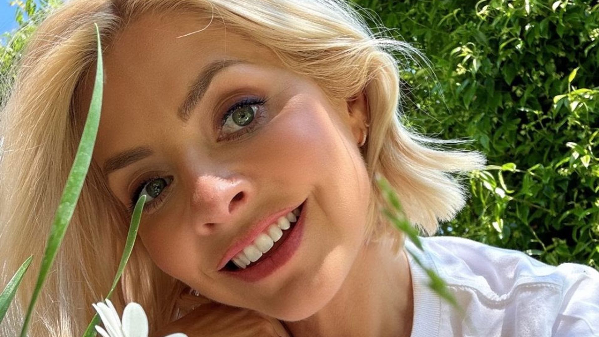 Holly Willoughby smiling in her garden