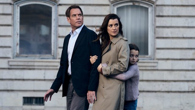 father, mother, daughter standing in street