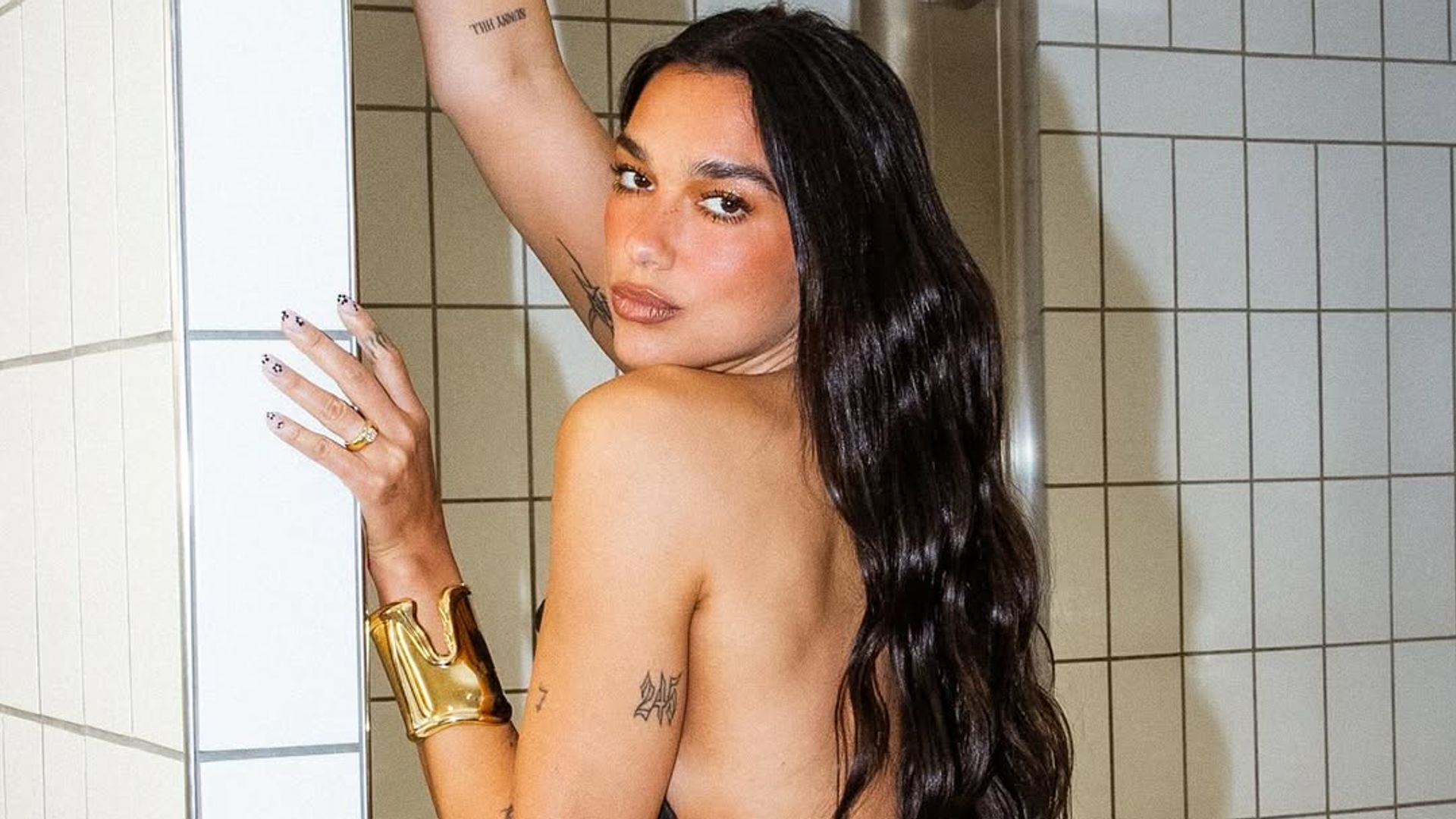 dua lipa with hair down and jeans