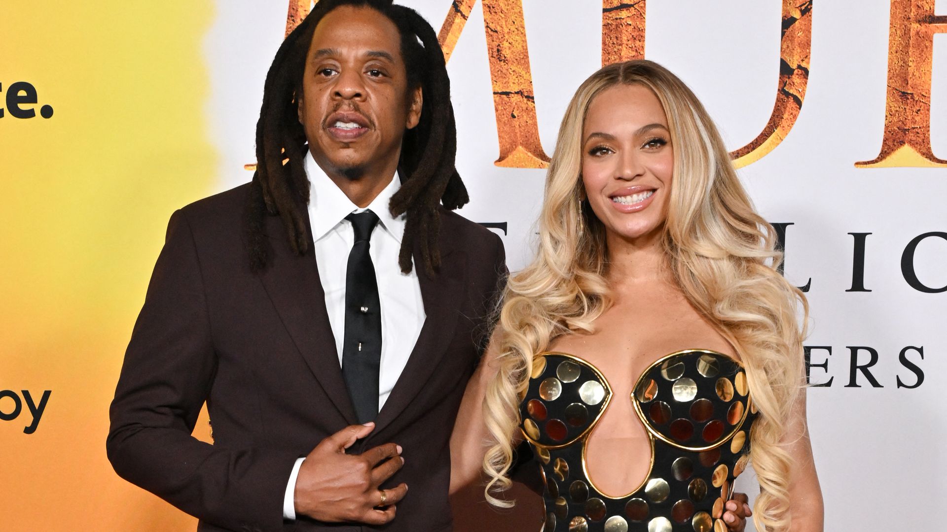 Jay-Z and US singer-songwriter Beyonce smiling with arms around eachother at the world premiere of Disney's "Mufasa: The Lion King''