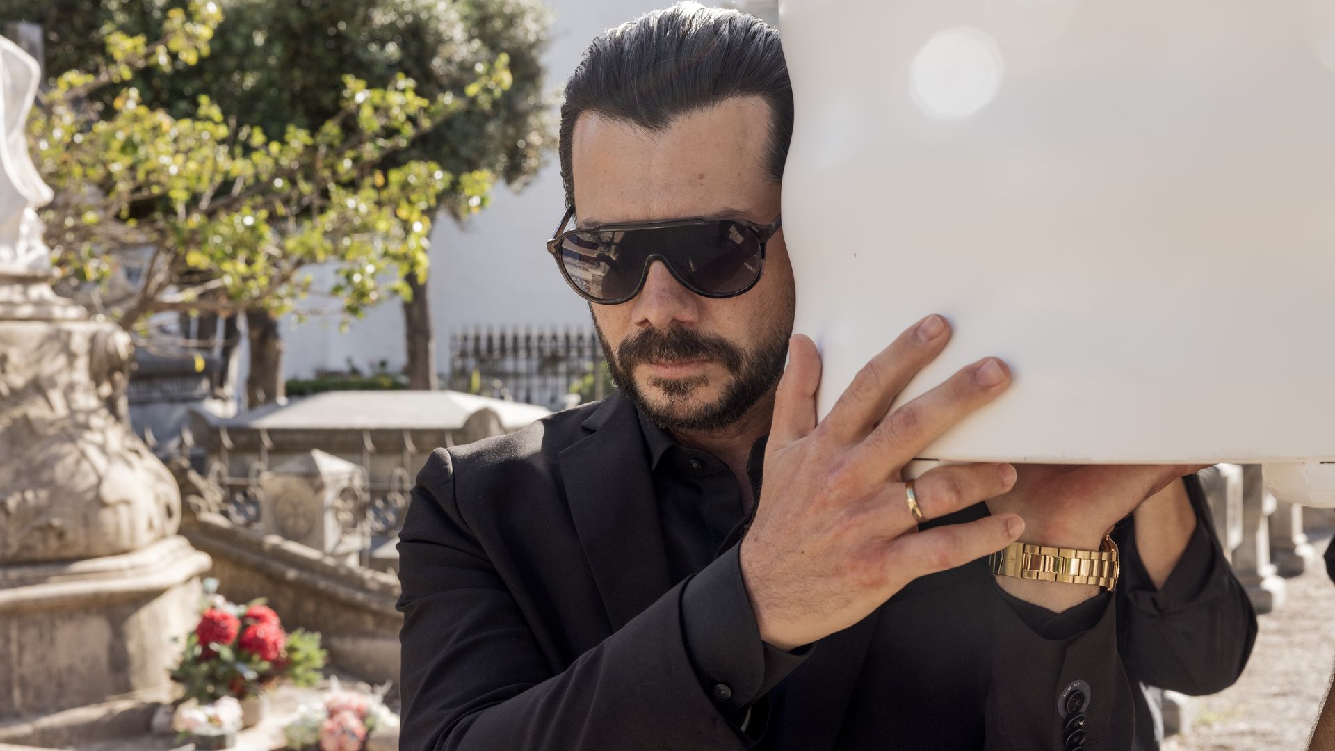 A man holds a coffin