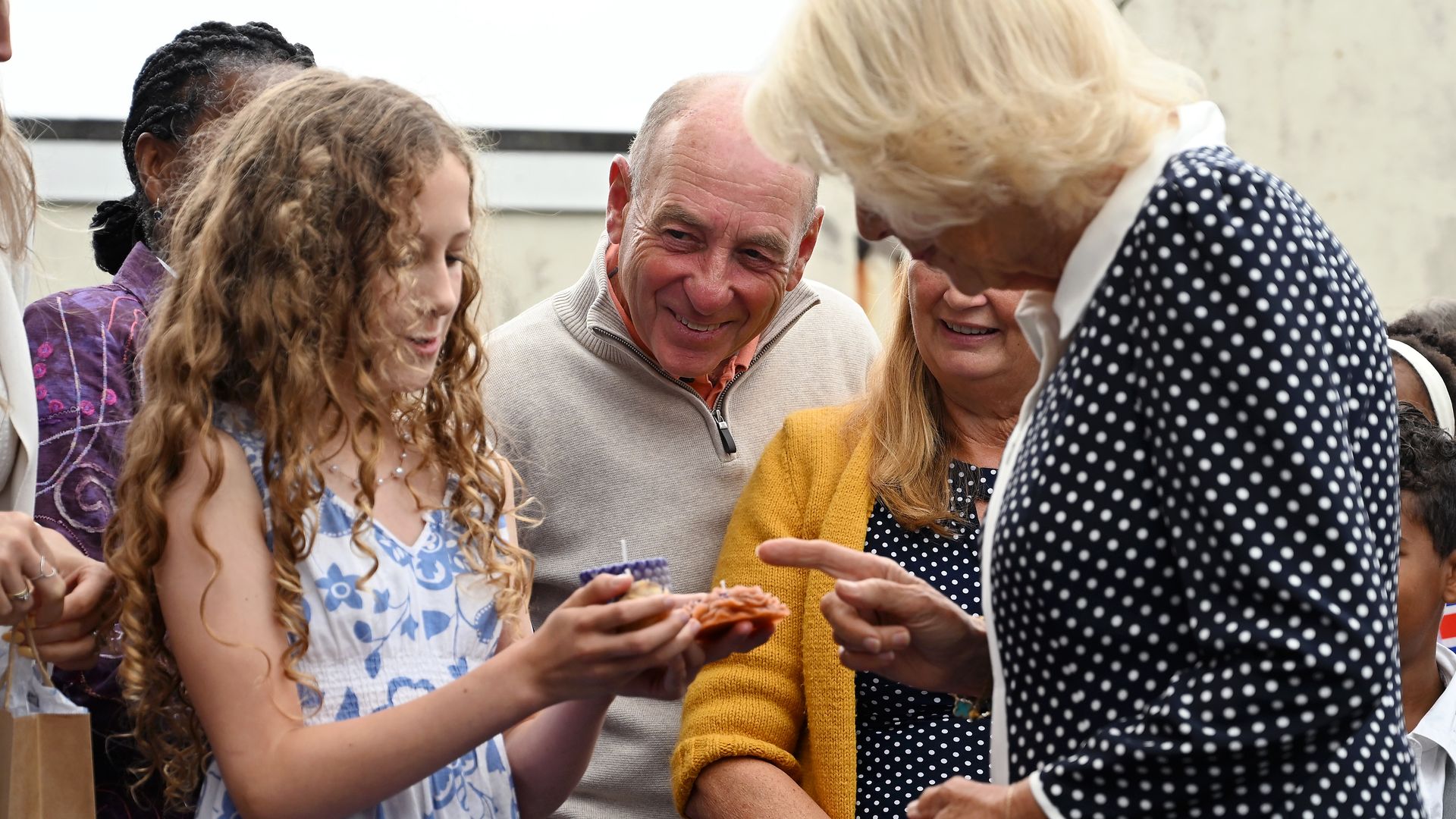 Queen Camilla recieving gifts from a young girl