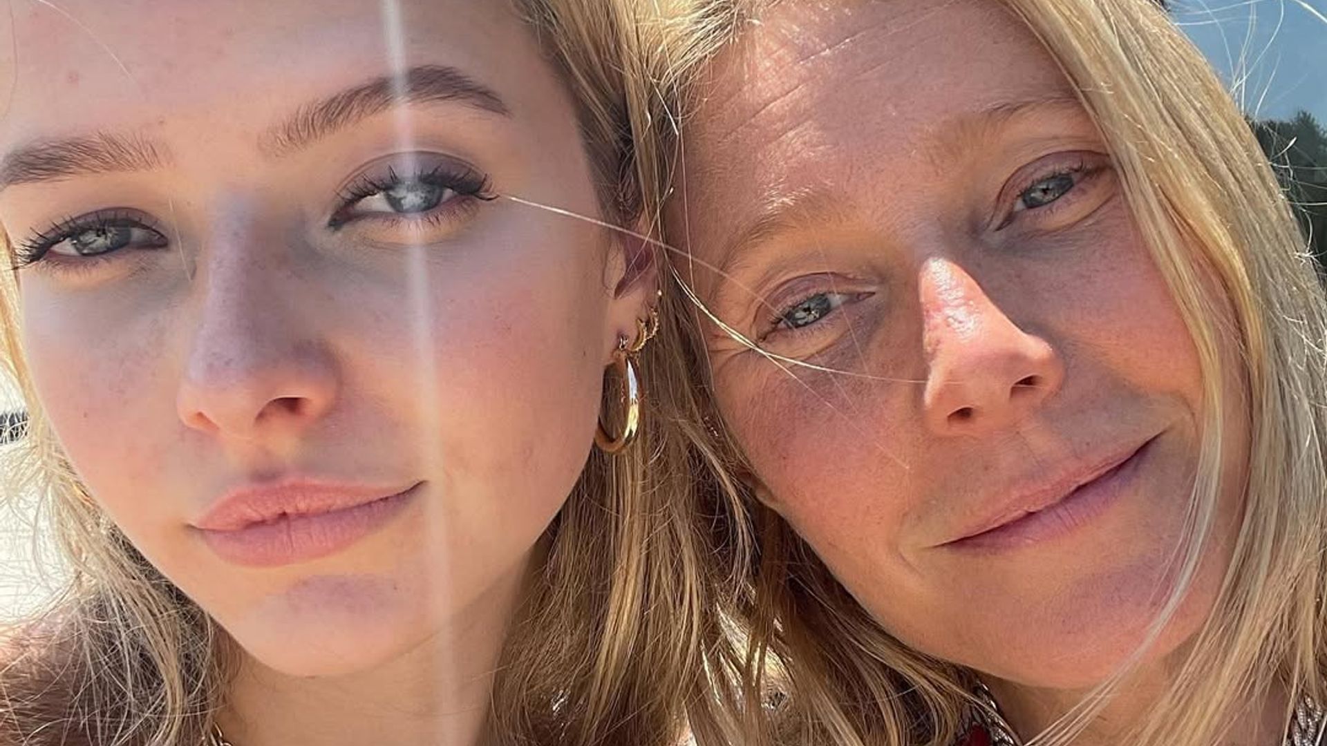 Gwyneth Patrow and Apple with their heads together posing