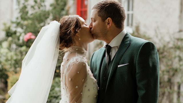 Faye Harris and Tyrone Wood kissing on their wedding day