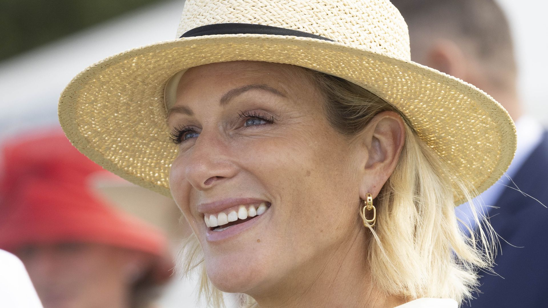 Zara Tindall side on in straw hat and striped dress
