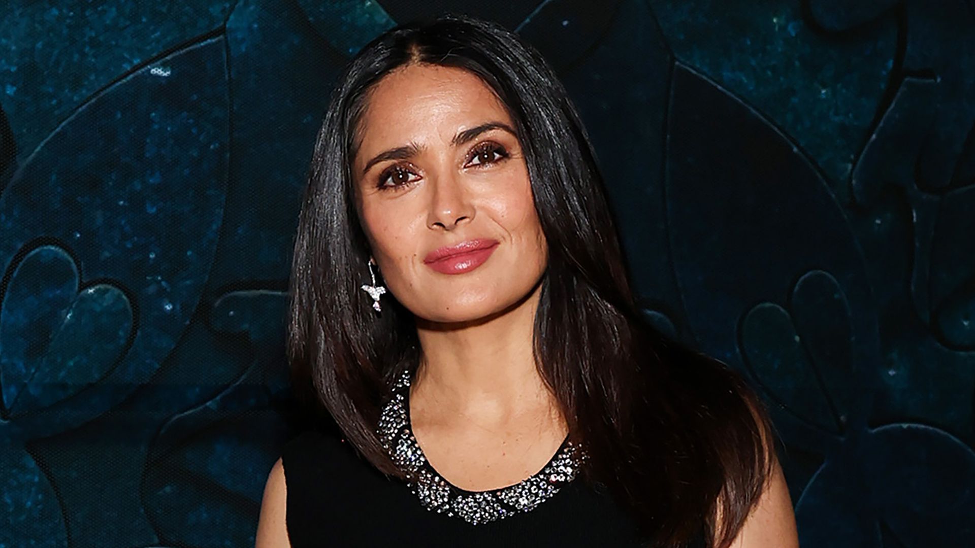 Salma Hayek wearing black silver detail top and matching earrings at Frequency vernissage