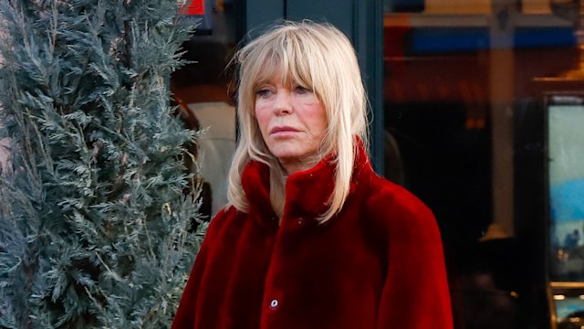 photo of goldie hawn in red fur coat walking in aspen