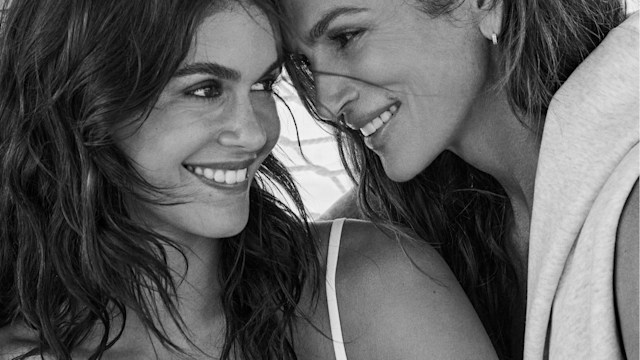 cindy and kaia gerber smiling on a beach