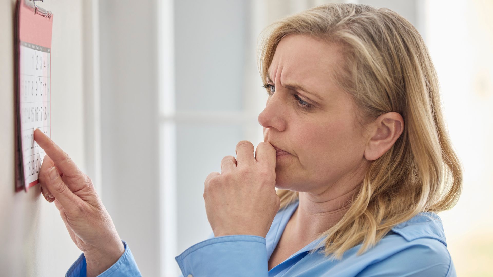 woman forgetting dates on calendar