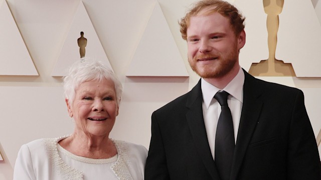 Judi Dench in a white dress with Sam Williams in a suit