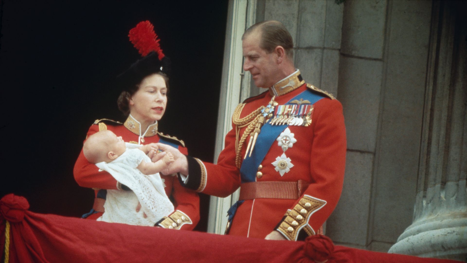 The Queen and Prince Philip carrying a baby Prince Edward