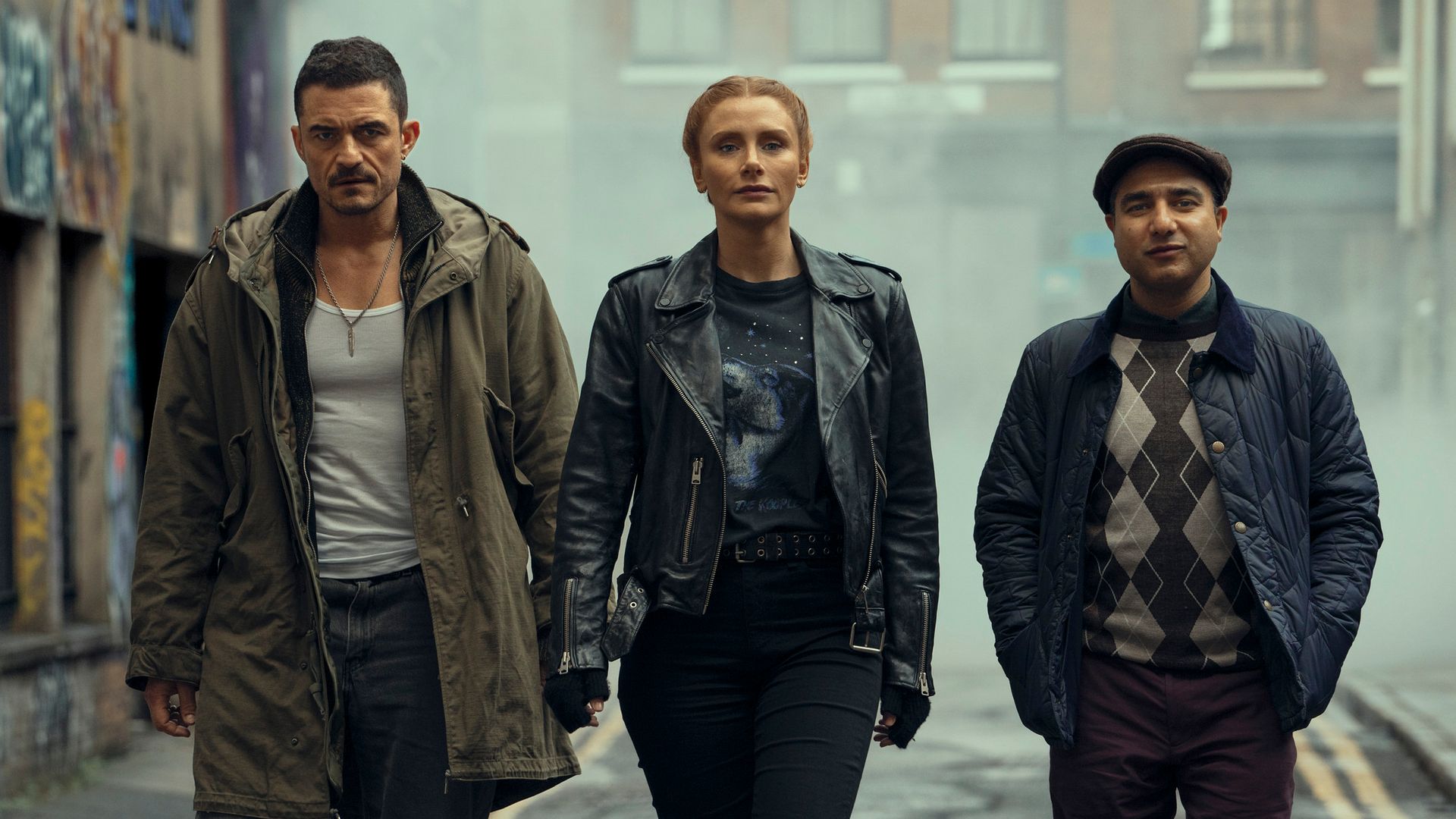 Three people walking down street