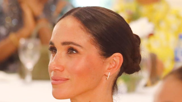 Meghan Markle wearing a red dress at a Women in Leadership event in Abuja, Nigeria. 