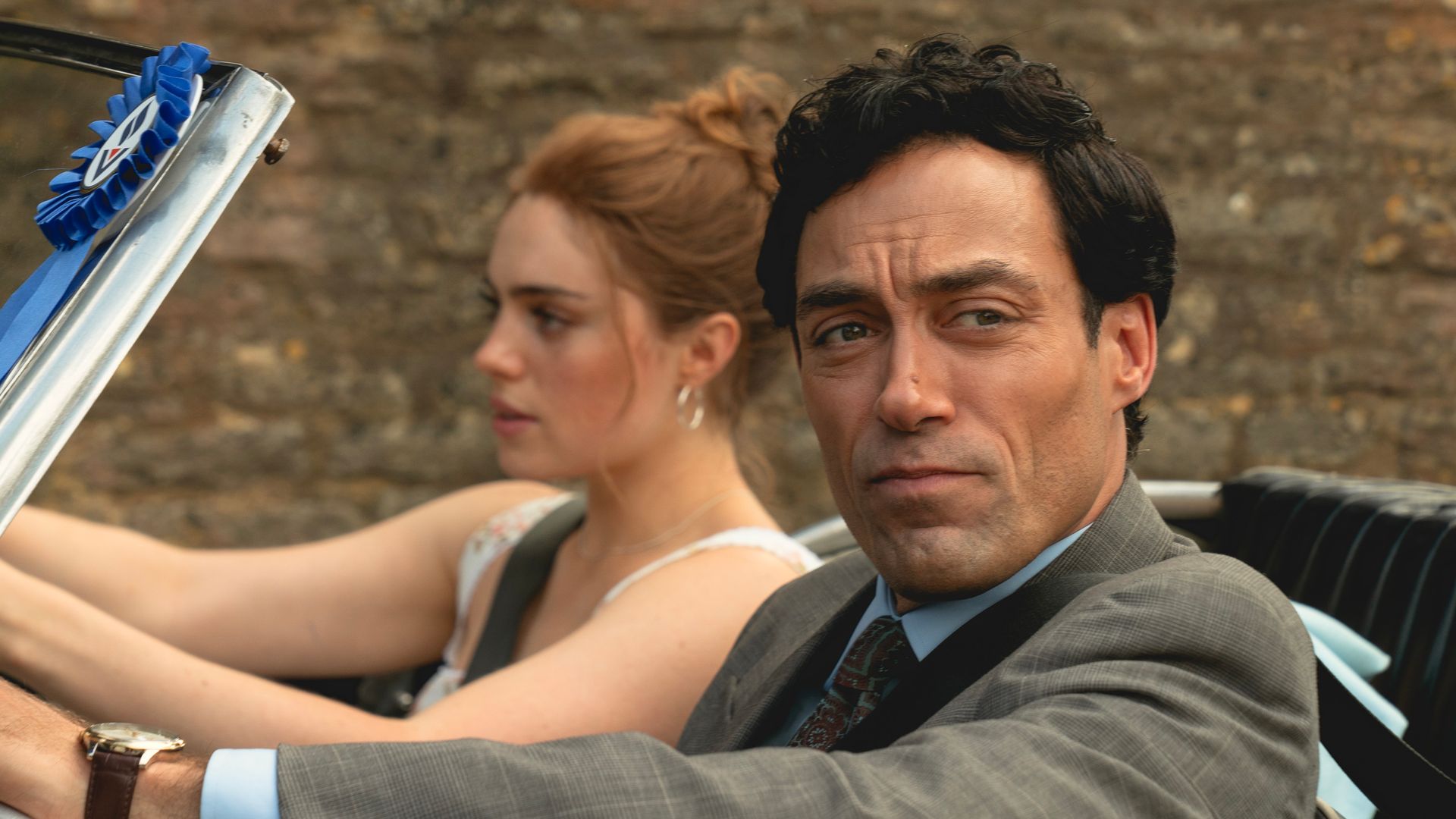 woman driving car, man in passenger seat