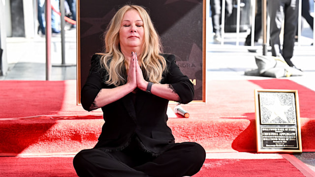 Christina Applegate sitting on hollywood walk of fame