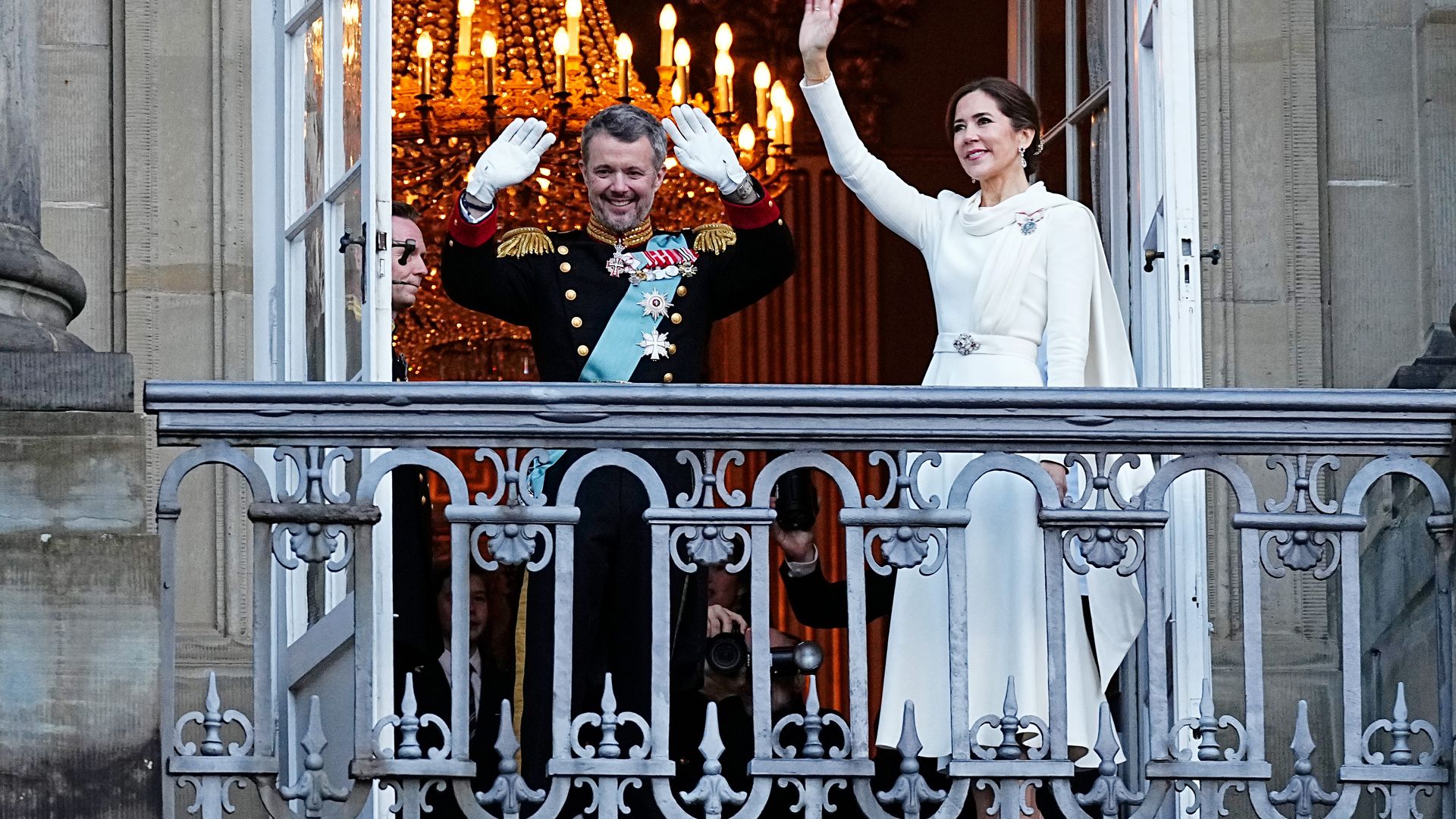 Frederik X and Queen Mary of Denmark wave from the balcony of Amalienborg