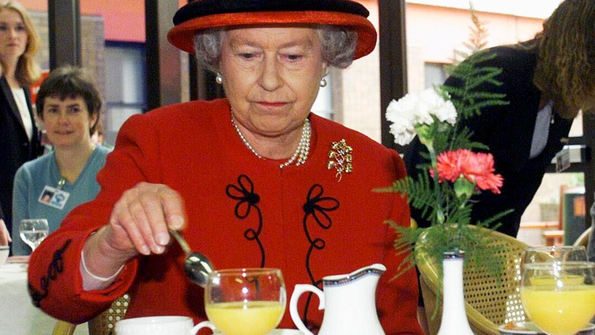 MANCHESTER - OCTOBER 15:  Queen Elizabeth II takes a tea break with hospital staff during her visit to Manchester Royal Infirmary on October 15, 1999. (Photo by Anwar Hussein/Getty Images)