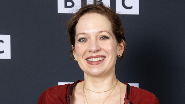 Katherine Parkinson in a red fleece in front of a grey background