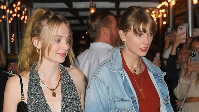 Taylor Swift and Sophie Turner draw a crowd as they exit arm in arm after dinner with friends at Via Carota in New York City.