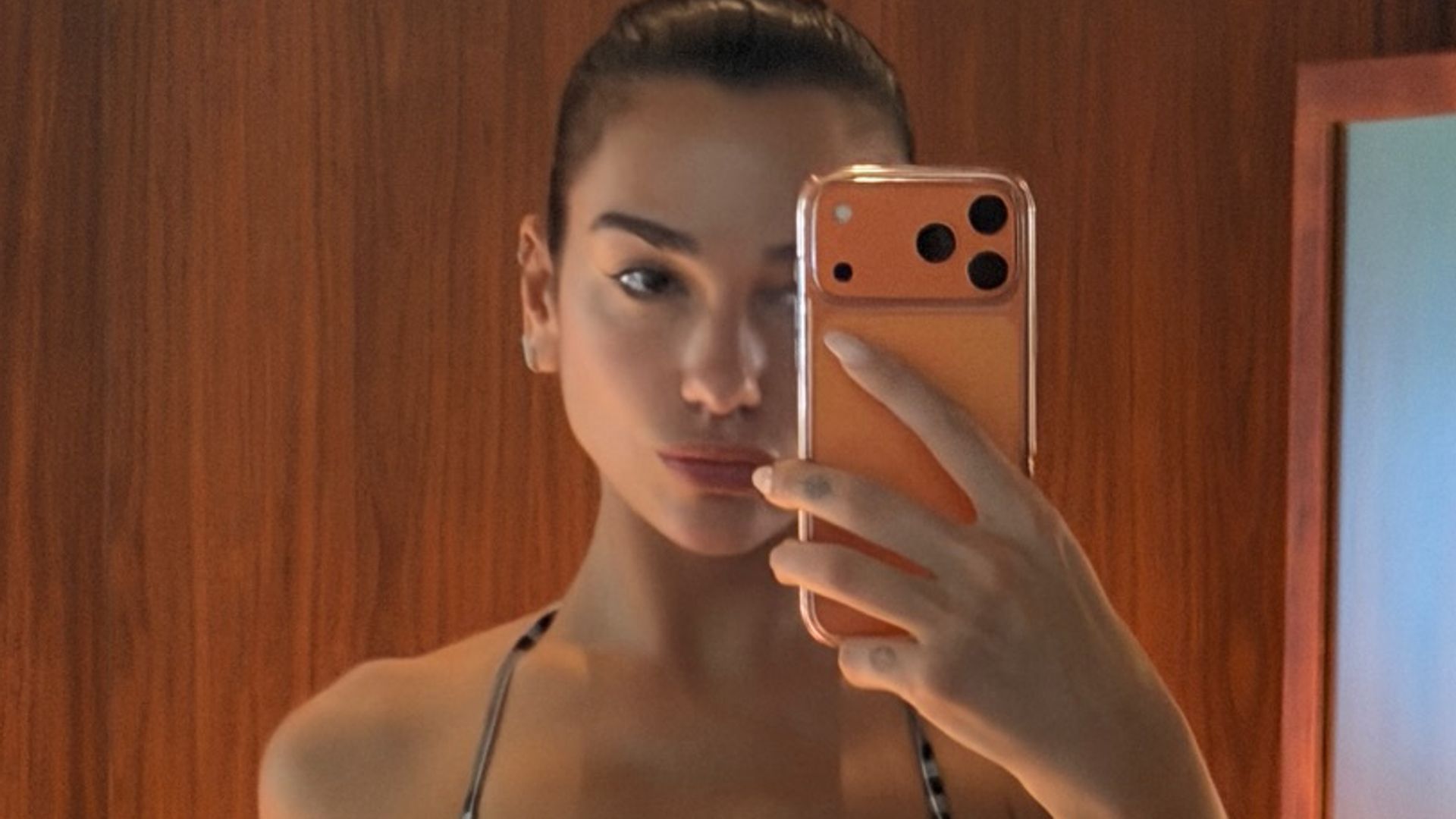 Bikini-clad Dua Lipa stuns alongside ripped fiancé Callum Turner in beachside photos